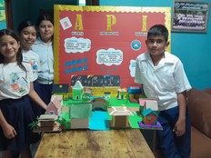 Students pose with the API prototype and project board.